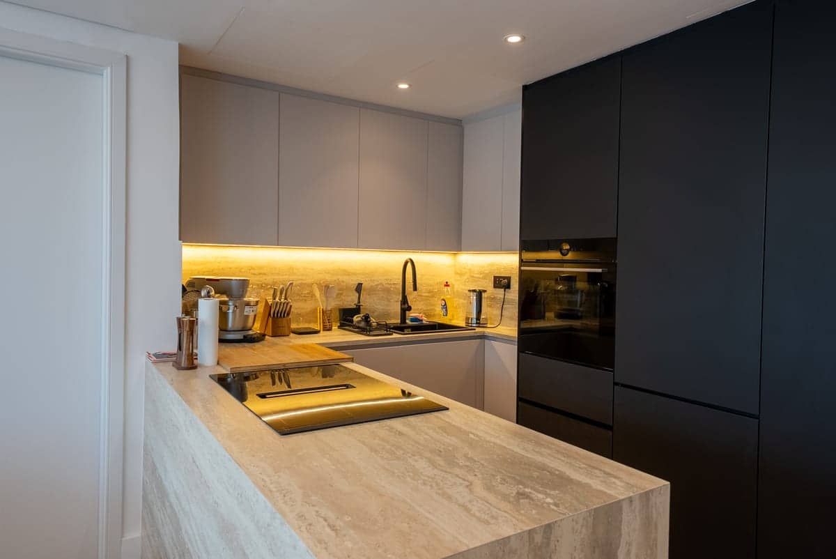 Kitchen dark cabinetry stone island — renovation in Dubai by Turnkey Renovations